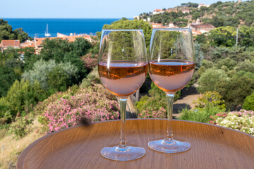 Summer vacation on Mediterranean sea, drinking cold rose wine in glass in sunlights, Collioure, Occitanie, South of France, tourists destination