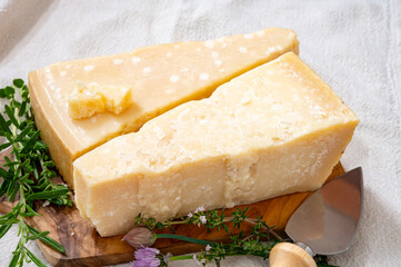 Traditional italian food, 36 months aged in caves Italian parmesan hard cheese from Parmigiano-Reggiano and grana padano from Po river valley, Italy