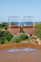 Summer vacation on Mediterranean sea, drinking cold rose wine in glass in sunlights, Collioure, Occitanie, South of France, tourists destination