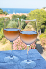 Summer vacation on Mediterranean sea, drinking cold rose wine in glass in sunlights, Collioure, Occitanie, South of France, tourists destination