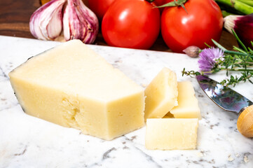 Pieces of matured pecorino romano italian cheese made from sheep milk in Lazio, Sardinia or Tuscany
