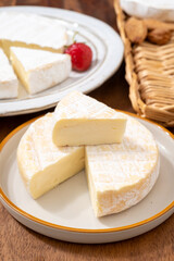 French soft cheeses collection, creamy cow's milk cheese le paysan and brie with white mold, France