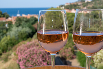 Summer vacation on Mediterranean sea, drinking cold rose wine in glass in sunlights, Collioure, Occitanie, South of France, tourists destination