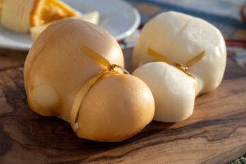 Italian semi hard handmade white and smoked scamorza cheese, from cow milk from Apulia or Calabria regions close up