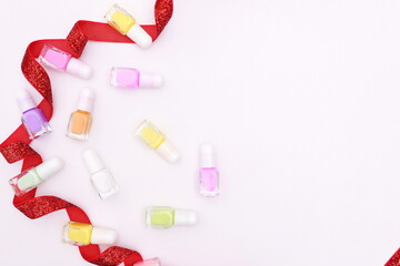 Nail polish bottles on Christmas decoration, holiday manicure concept