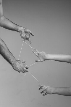 Naklejki Hands Holding String in Moody Black and White