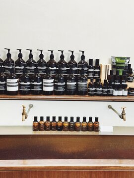 29.05.2025, Kuala Lumpur, Malaysia. Aesop skincare bottles in brown glass with black labels neatly arranged on shelves above a wash sink in store. Minimalist and luxury design. Luxury skincare.