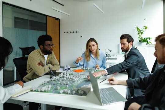 Team of serious architects talking about new residential project