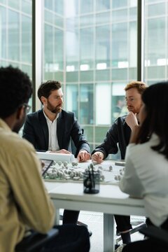 Group of multiethnic architects thinking about residential project