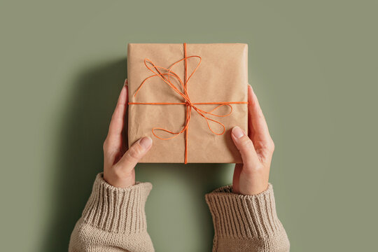 Autumn and winter vibes, Thanksgiving day, winter holidays present, seasonal sale concept. Woman holding handcrafted gift box. Fall composition