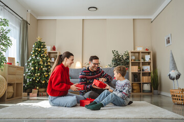 Family enjoying christmas morning gift exchange together
