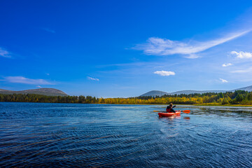 Boy Kayaking on Lake with View of Yll&auml;s Fells, Autumn Lapland Finland