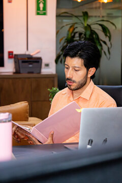 An office employee focused on completing tasks at a shared desk