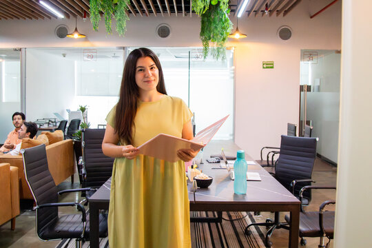 Corporate portrait of a worker posing in a coworking boardroom