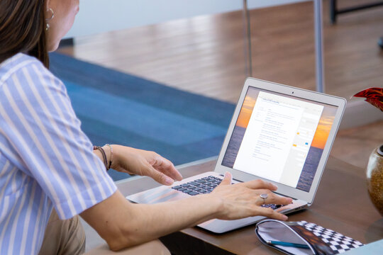 Female office worker sitting in a coworking lounge using a laptop