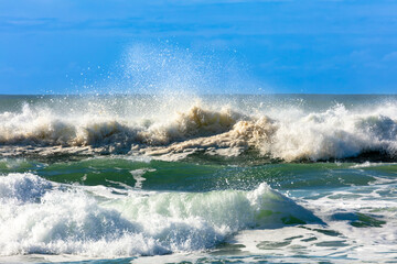 Photograph of waves from the Tasman Sea crashing onto Jones Beach against a blue sky near the town of Kiama Downs in the Illawarra region on the south coast of NSW, Australia.