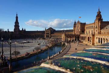 Fototapeta premium Iconic Plaza de España in Seville, Spain - Stunning Renaissance Revival architecture with canal, bridges and tourists on a sunny day