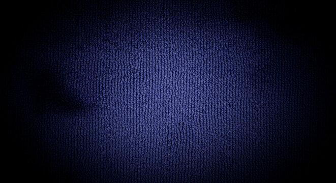 Dark blue fabric texture, ribbed pattern, showing depth and shadow, ideal for background or design element, conveying a sense of mystery or sophistication