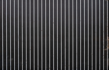 Obraz premium Old worn door of a barn with black and white stripes in Sint Laureins, East Flanders, Belgium