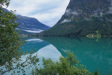  reflection of the sky and mountains in the water - Stryn, Norway