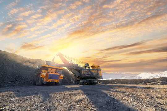 Open-pit coal mining in winter sunset landscape
