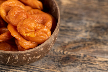 orange dried apricots made from ripe apricots in a plate, dried apricots in a bowl made from natural materials