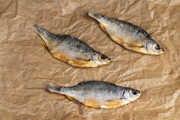 dried fish for long-term storage by dehydrating whole fish in the sun, semi-finished product of dehydrated and dried fish in scales ready for human consumption