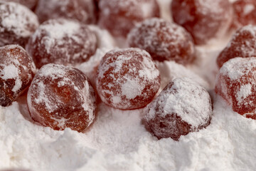 kumquat and powdered white sugar, sweet dried orange kumquat fruits in white powdered sugar