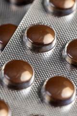 brown tablets in a plastic blister to ensure the safety of the medicine, blisters with brown tablets