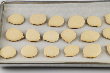 Homemade cookies topped with meringue frosting, freshly baked on a white background with copy space