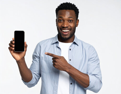 Happy man in blue shirt presenting blank smartphone screen, pointing finger,  Mockup studio shot, white background. - Powered by Adobe