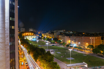 Night view of Fonte Luminosa in Lisbon showcasing vibrant lights and urban activity
