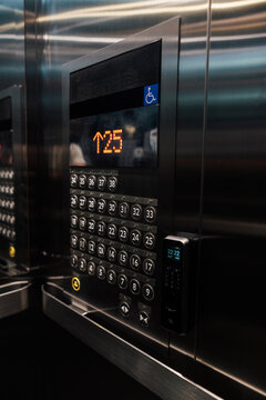 Elevator panel shows floor 25, with many floor buttons