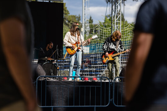 Music band performs on an open-air stage