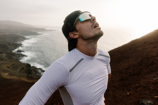 Professional athlete catching his breath after a trail running routine