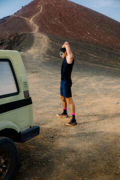 Fit man performing arm stretches as part of his outdoor sports routine
