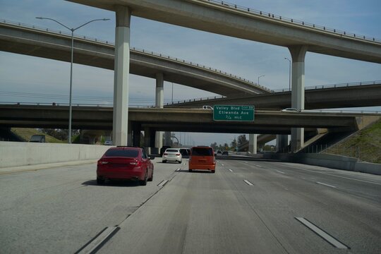 Cars Navigating a Busy Freeway Interchange in the Afternoon