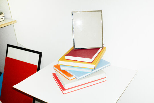 Silver photo frame on top of book pile in work office business desk