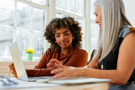 Mature woman is working on laptop