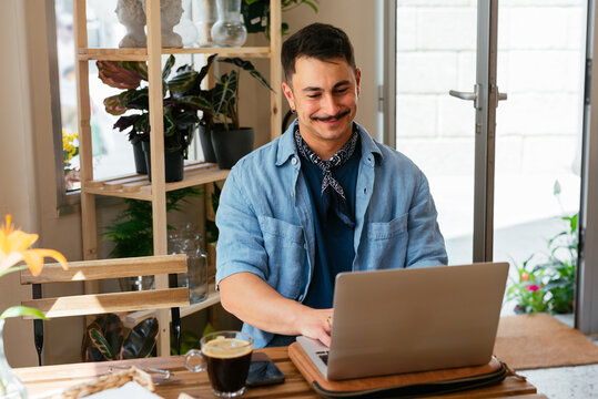 Man working at a coffee shop with laptop
