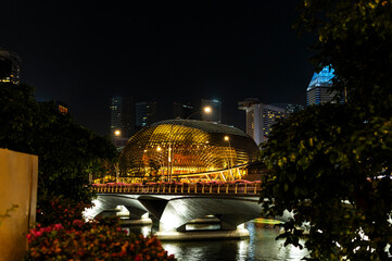 Golden dome theater glowing over the night bridge