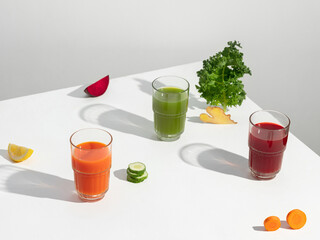 Colorful juice bottles and fresh ingredients