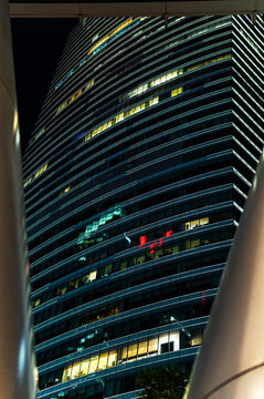 Curved skyscraper with lightning patterns and urban design