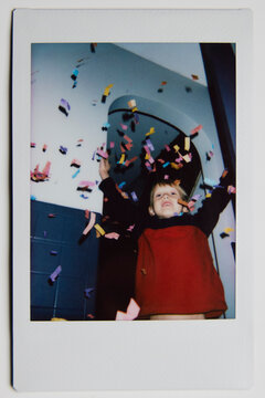 Polaroid of a happy little boy throwing confetti