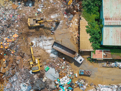 Aerial View Recycling Facility Scrap Yard with Excavators and Tr - Powered by Adobe