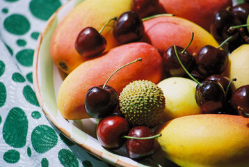Colorful fruit platter featuring mangos, cherries, and lychee