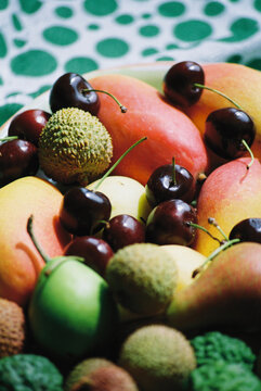 Colorful assortment of fresh fruits on a patterned background
