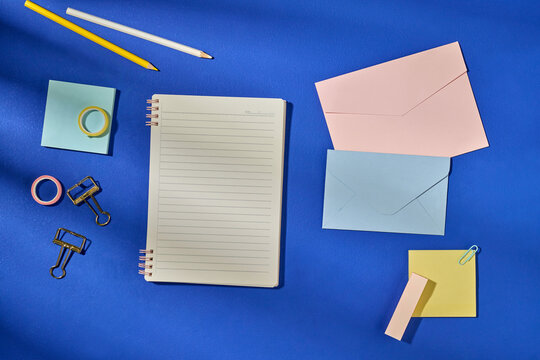 Organized Stationery Items on Vibrant Blue Background for Office