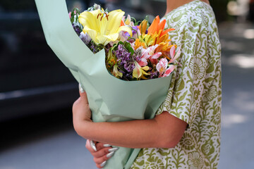 Woman Holding a Wrapped Bouquet of Fresh Flowers