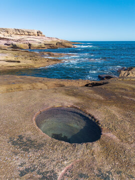 Circular rock pool in granite rock at Talia Caves. South Australia.